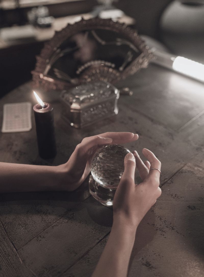 hands around crystal ball